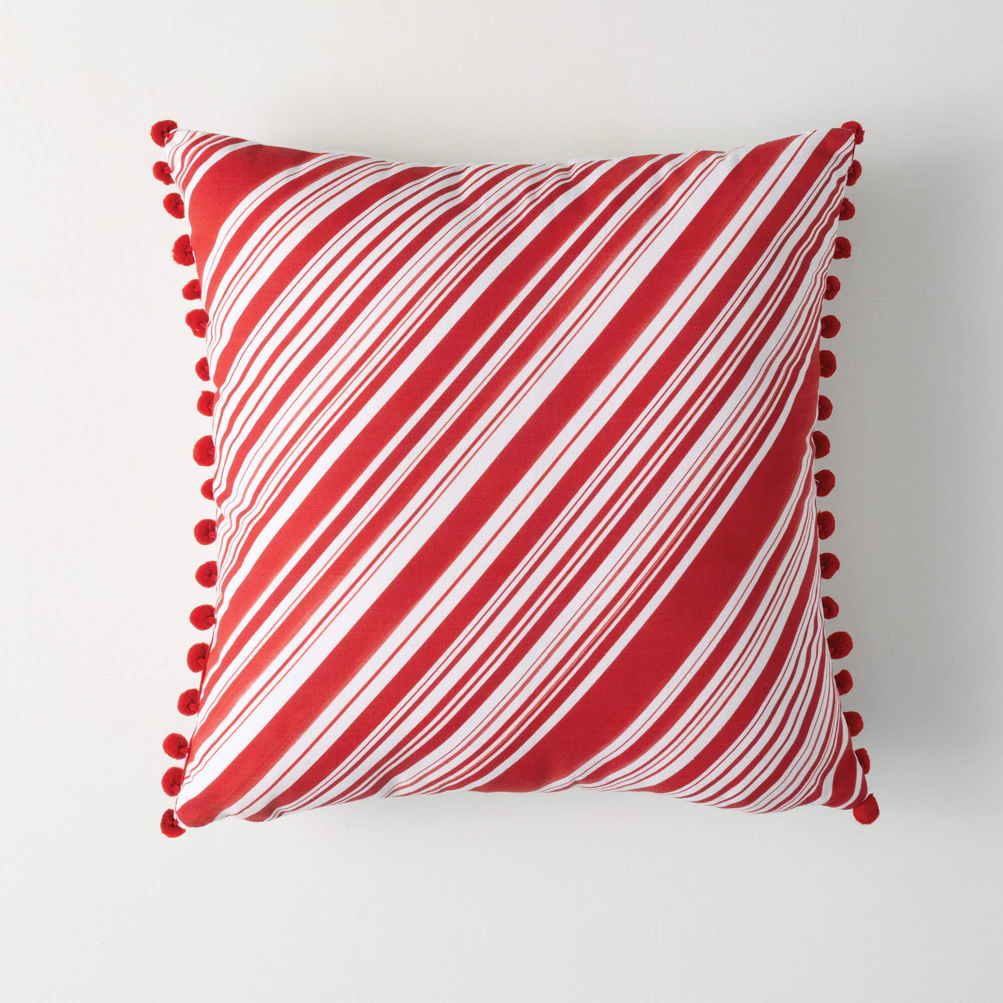 STRIPED PILLOW WITH POM POMS